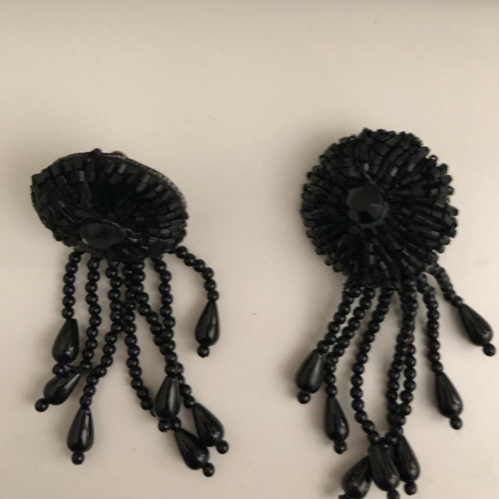 Long black resin bead earrings with a click closure